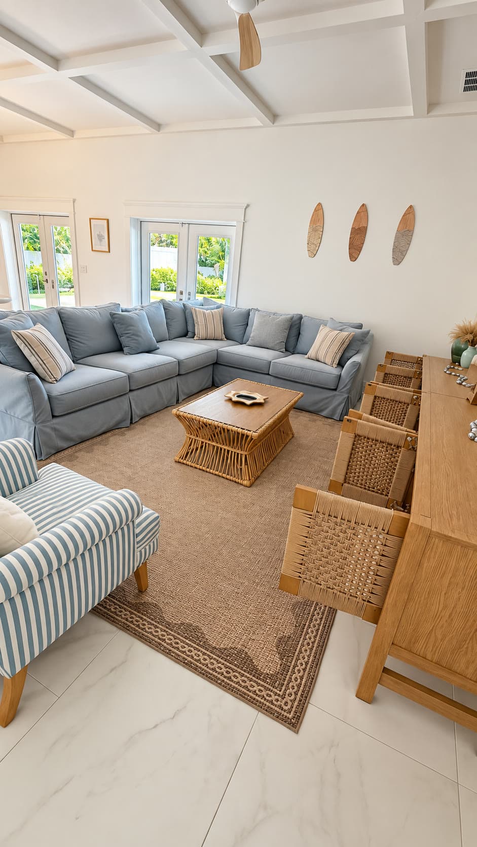 Living room after cleaning: Bright living room with a blue sectional sofa, tidy rattan coffee table, and freshly cleaned tile floors